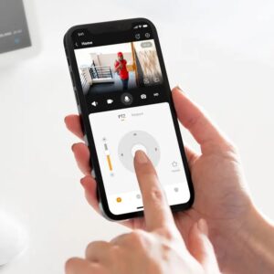 Hands operating the IMOU smartphone app, showing live view of a person at the door and PTZ controls for the IMOU Cruiser SC outdoor camera.